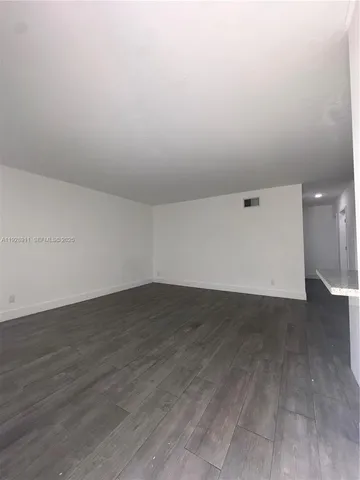 an empty room with wooden floor