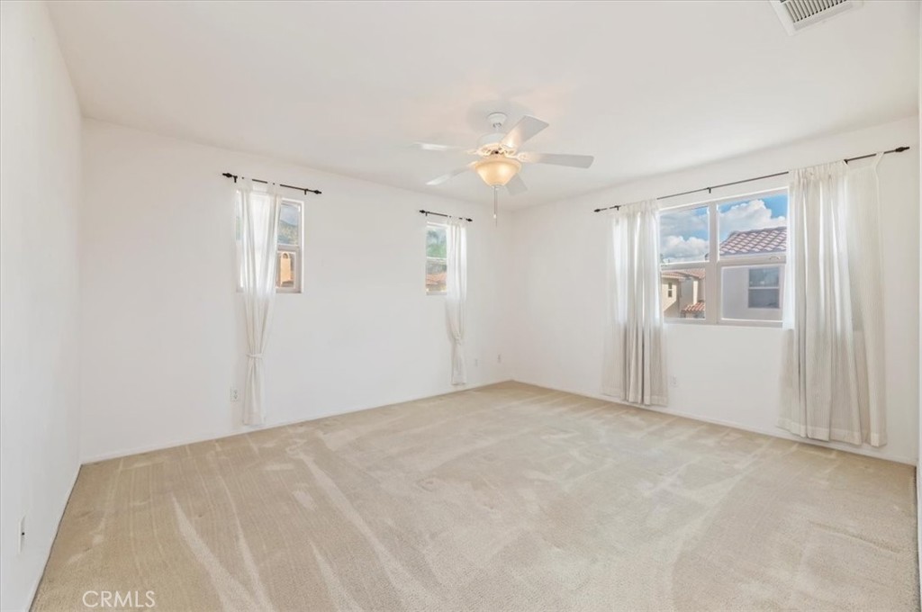 2454 Crossroads Court Duarte, CA 91010 - Photo 18 of 33 Primary Bedroom AS IS. Lots of natural light in from multiple windows. Ceiling fan for those warmer nights.