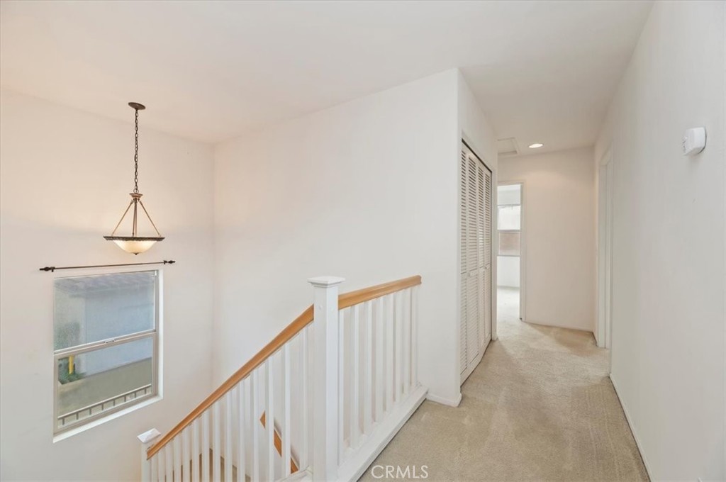 2454 Crossroads Court Duarte, CA 91010 - Photo 22 of 33 Upstairs view of hallway from primary bedroom. On the left is the laundry room with the bi fold doors.