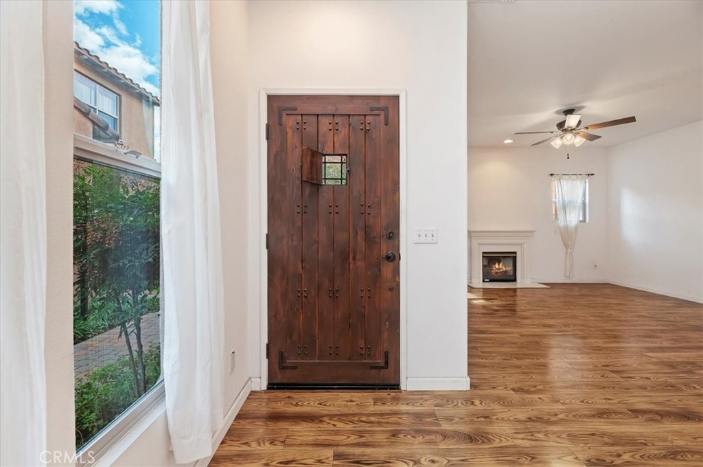 2454 Crossroads Court Duarte, CA 91010 - Photo 6 of 33 Entry way with sold wood rustic door and showing wood laminate flooring.