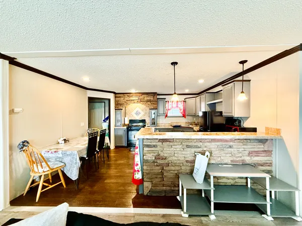 a kitchen with kitchen island a stove and a table