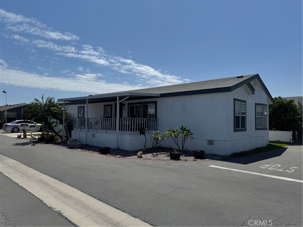 39 Spruce Via Anaheim, CA 92801 - Photo 2 of 10 a front view of a house with a yard and garage
