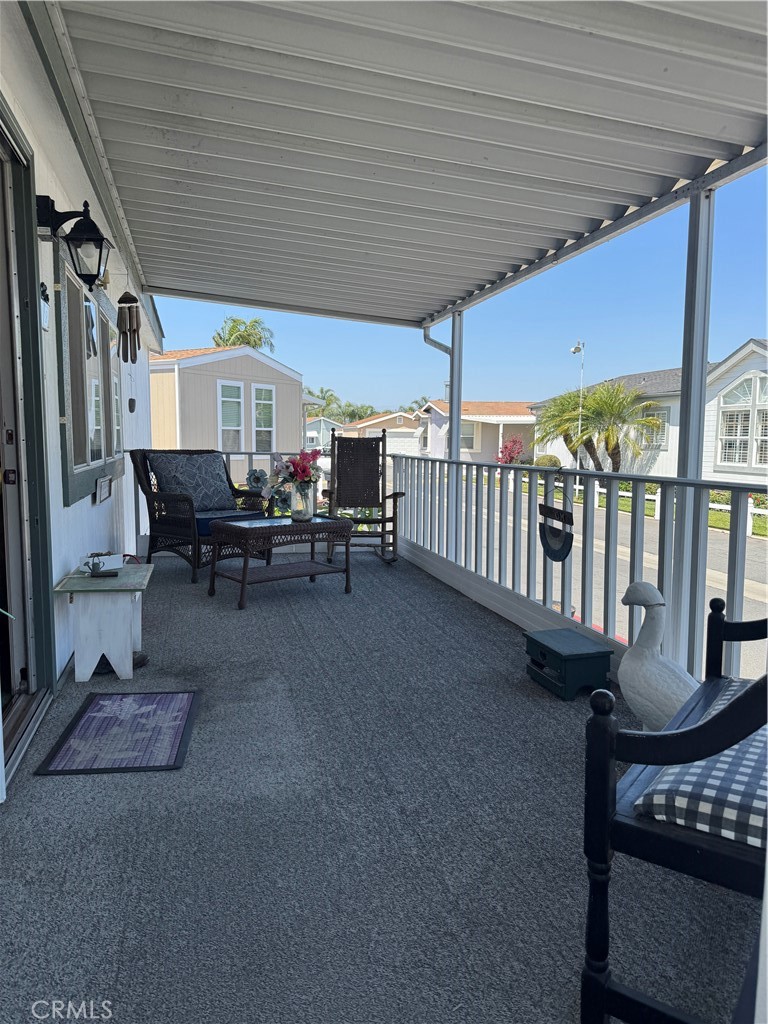 39 Spruce Via Anaheim, CA 92801 - Photo 4 of 10 a view of a patio with table and chairs with wooden floor and fence