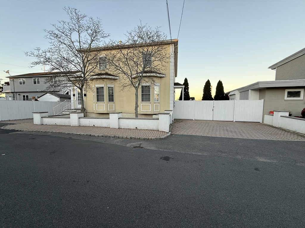 a view of a car park front of a house