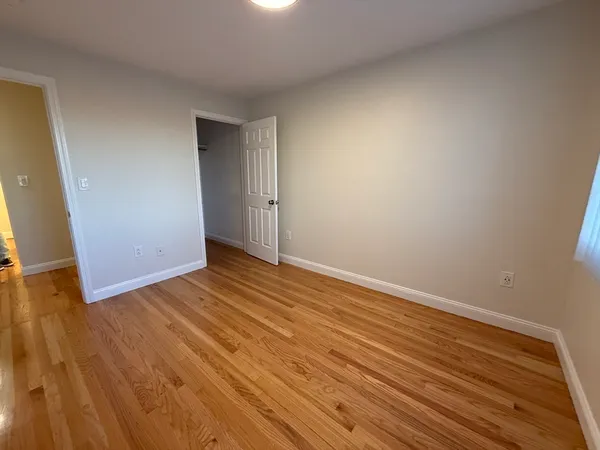 a view of room with wooden floor