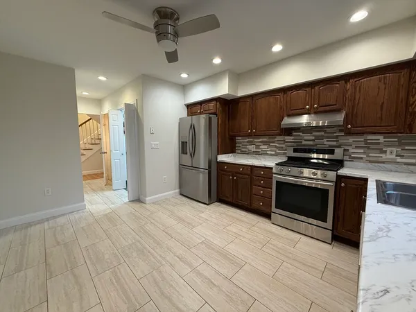 a kitchen with stainless steel appliances granite countertop a stove and a refrigerator