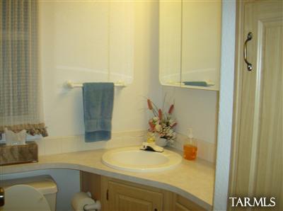 74 Cardinal Corner Benson, AZ 85602 - Photo 4 of 21 a bathroom with a sink and a mirror