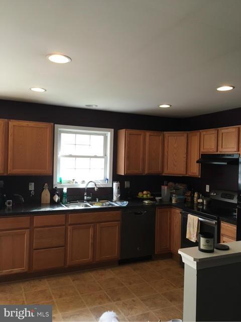 3355 Bayside Road Huntingtown, MD 20639 - Photo 4 of 15 a kitchen with granite countertop a sink window and cabinets