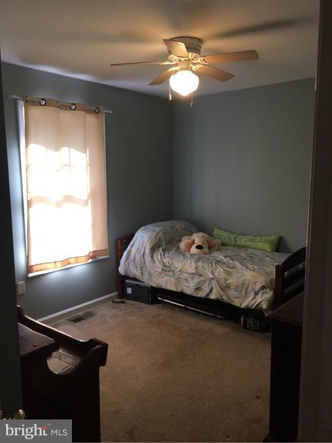3355 Bayside Road Huntingtown, MD 20639 - Photo 8 of 15 a bedroom with a bed and a window