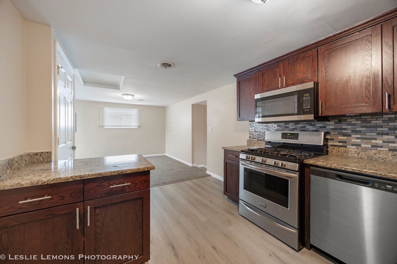 4949 Paxton Road Oak Lawn, IL 60453 - Photo 11 of 29 a kitchen with granite countertop wooden cabinets stainless steel appliances and a sink