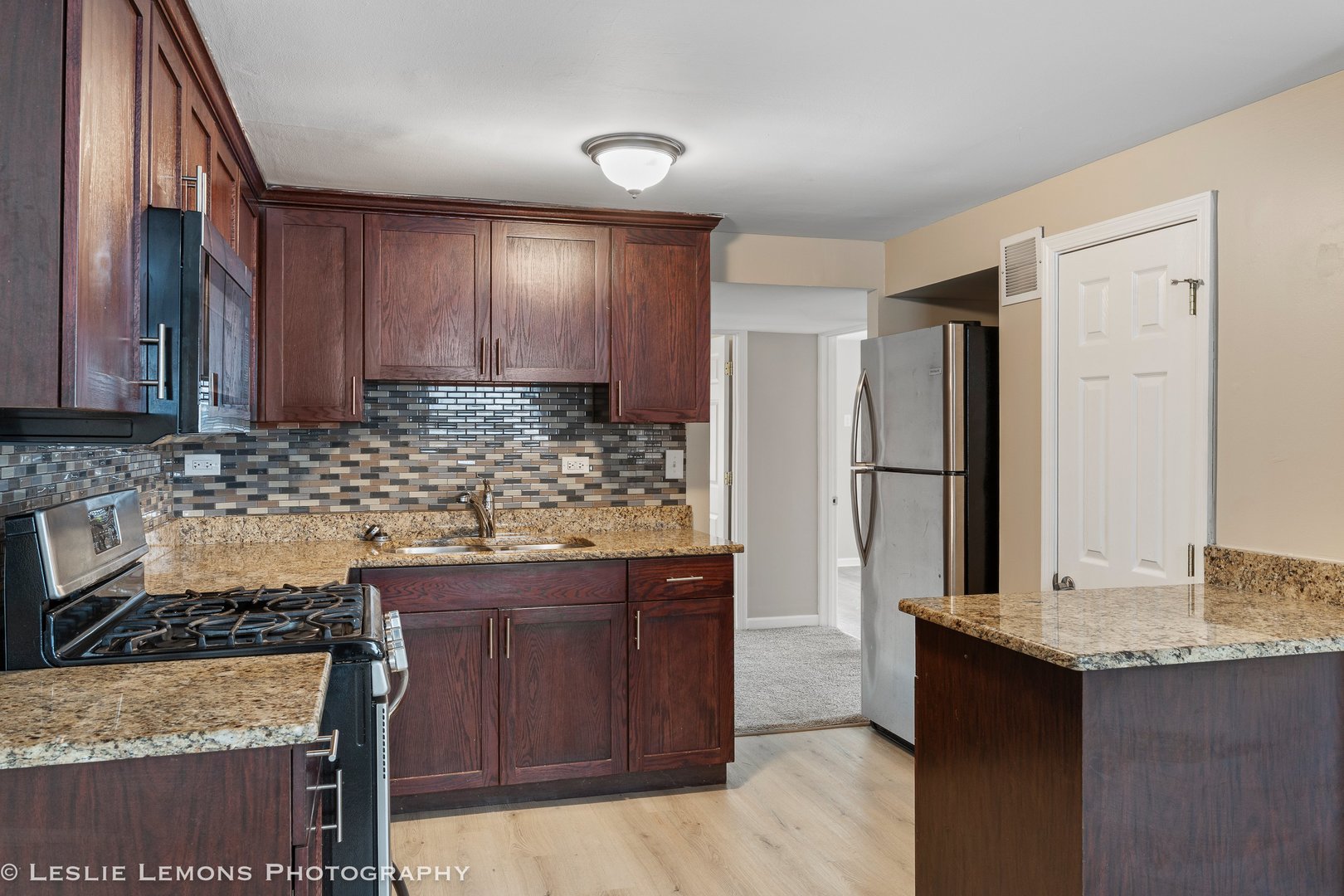 4949 Paxton Road Oak Lawn, IL 60453 - Photo 10 of 29 a kitchen with granite countertop a sink stove and refrigerator