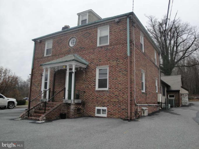 9702 Harford Road Baltimore, MD 21234 - Photo 1 of 17 a front view of a house with a yard