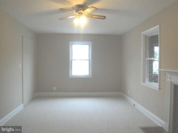 9702 Harford Road Baltimore, MD 21234 - Photo 15 of 17 an empty room with a window and a fan