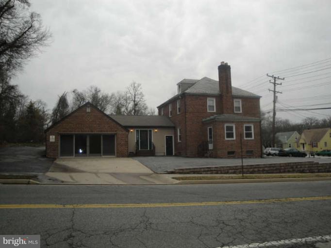 9702 Harford Road Baltimore, MD 21234 - Photo 3 of 17 a front view of a house with a garden