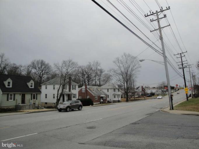 9702 Harford Road Baltimore, MD 21234 - Photo 5 of 17 a view of road with card and parked cars