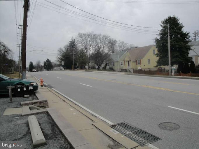 9702 Harford Road Baltimore, MD 21234 - Photo 6 of 17 a view of a street with a car parked on the road