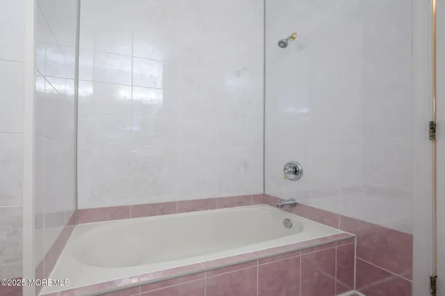 a bathroom with a tub and shower