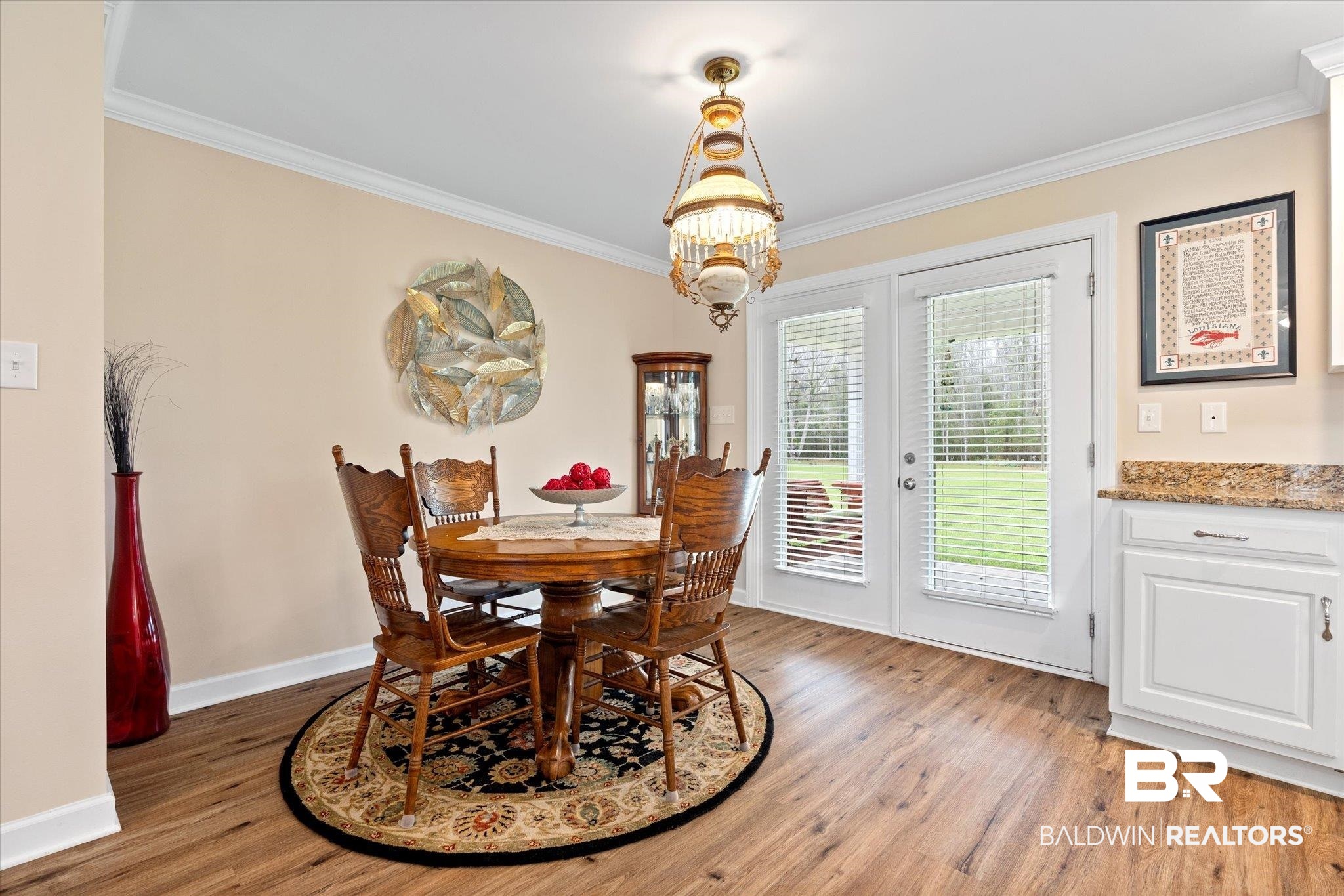 734 West Section Avenue Foley, AL 36535 - Photo 12 of 50 Dining space featuring light wood-style flooring, an inviting chandelier, crown molding, and baseboards