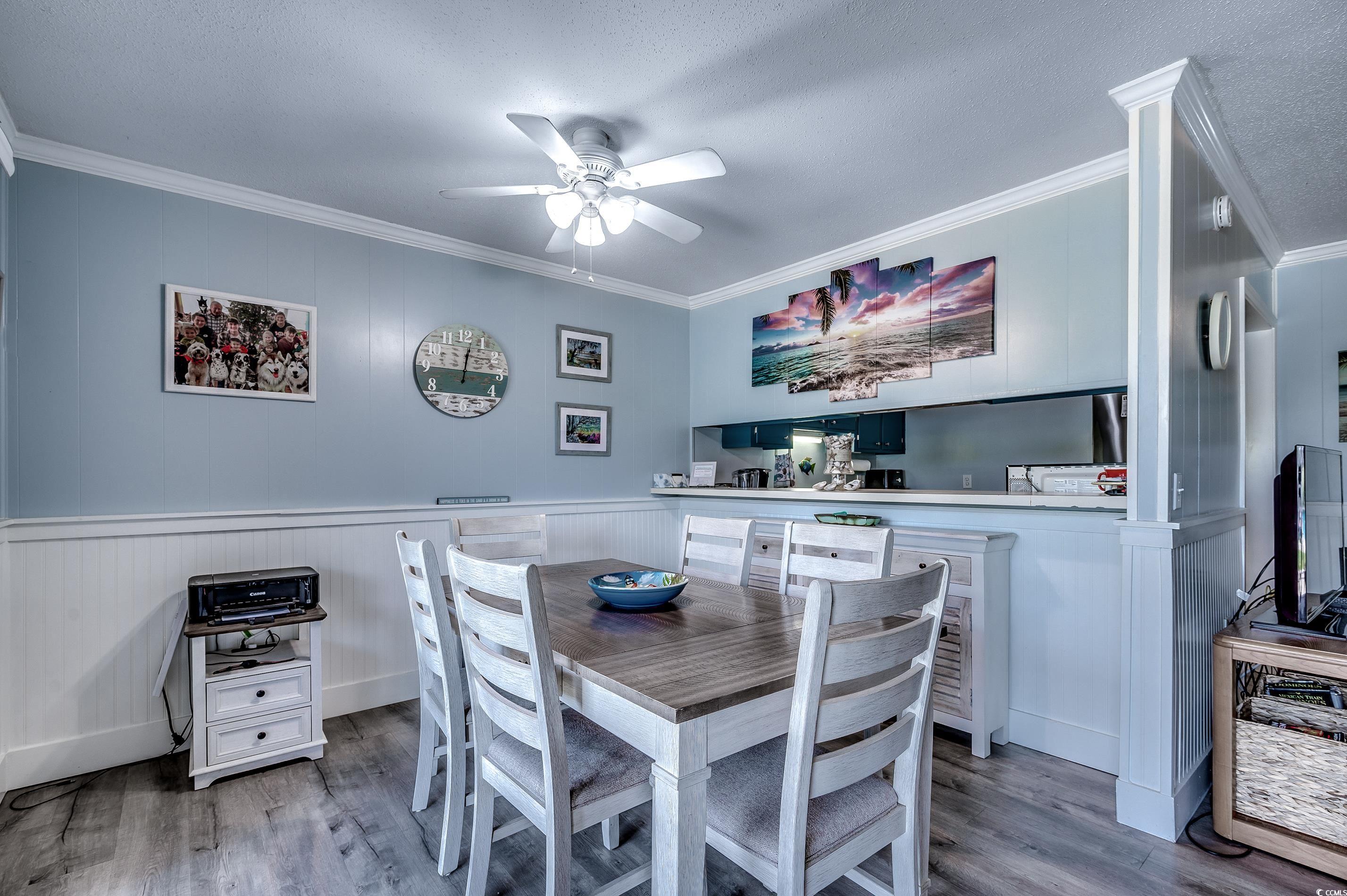 416 North Ocean Boulevard, Unit B7 Surfside Beach, SC 29575 - Photo 8 of 30 Dining space featuring crown molding, light wood-style floors, and ceiling fan
