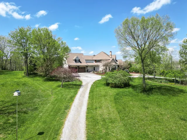 a view of a dining room with furniture a chandelier and a rug