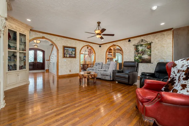 a living room with furniture a chandelier and a window
