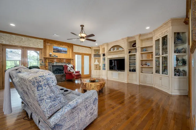 a view of a livingroom with a ceiling fan and a chandelier fan