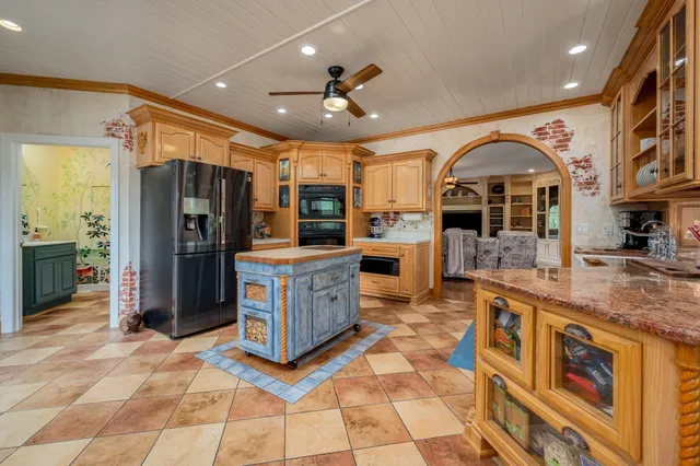 a view of an empty room with wooden floor and windows