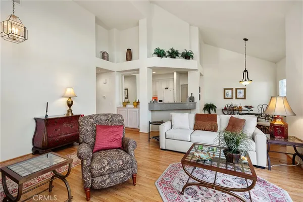 a living room with furniture a rug and a chandelier