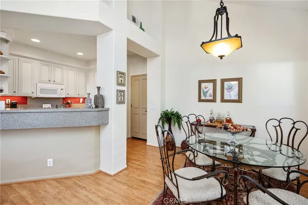 a living room with stainless steel appliances kitchen island granite countertop furniture and a dining table