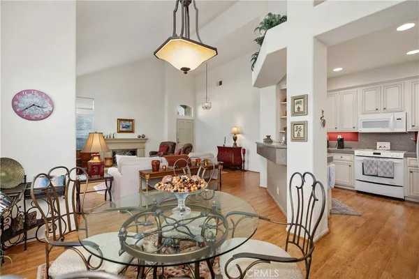 a living room with furniture a dining table and a chandelier