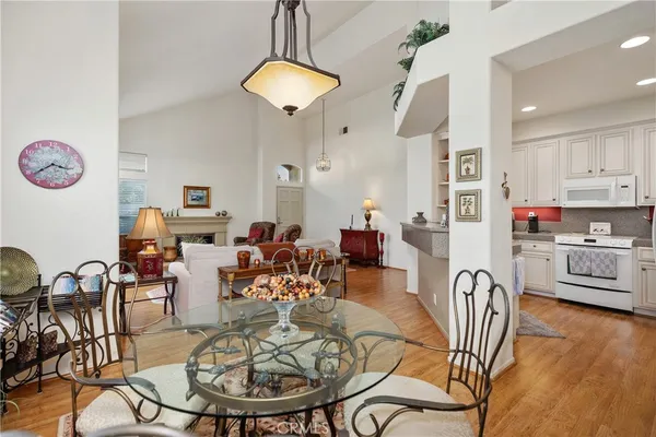 a living room with furniture a dining table and a chandelier