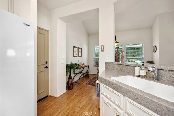 a spacious bathroom with a granite countertop double vanity sink and a mirror