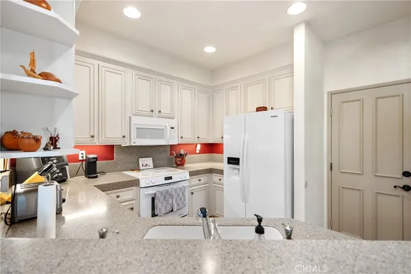a room with furniture a white cabinet and a window