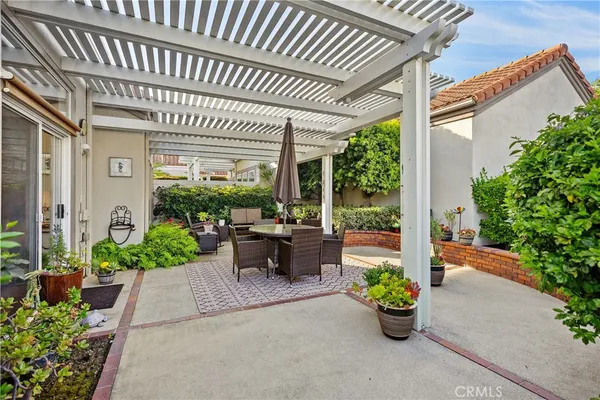 a view of a patio with chairs and potted plants