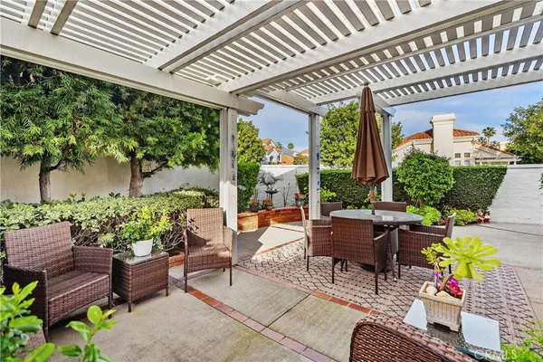a building outdoor space with patio furniture and potted plants