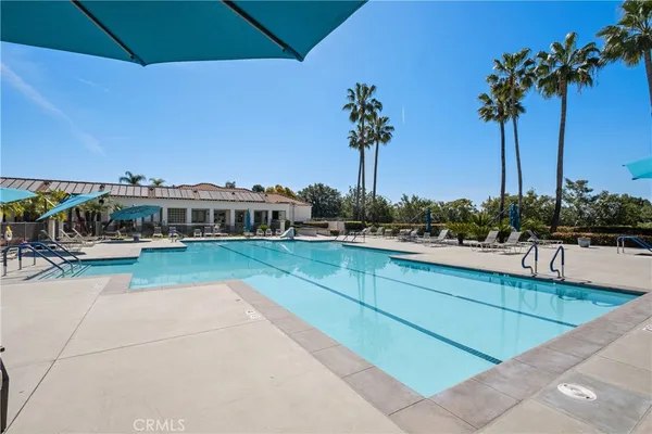 a view of a swimming pool with a table and chairs
