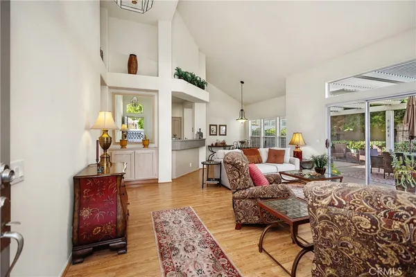 a living room with furniture and a chandelier