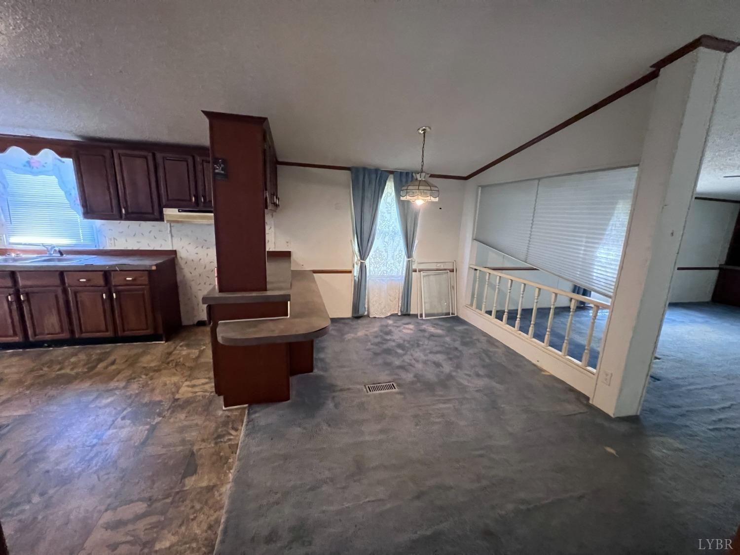 5507 Wards Road Evington, VA 24550 - Photo 15 of 15 a large kitchen with a wooden floor and cabinets