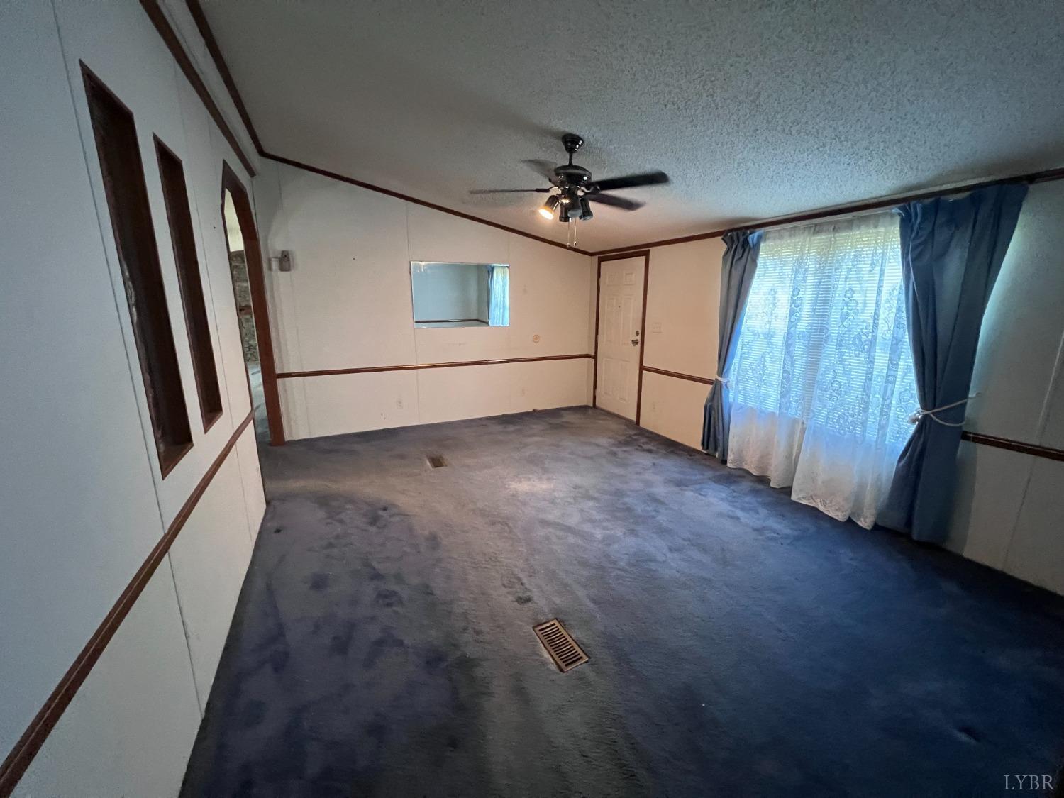 5507 Wards Road Evington, VA 24550 - Photo 7 of 15 wooden floor in an empty room with a window