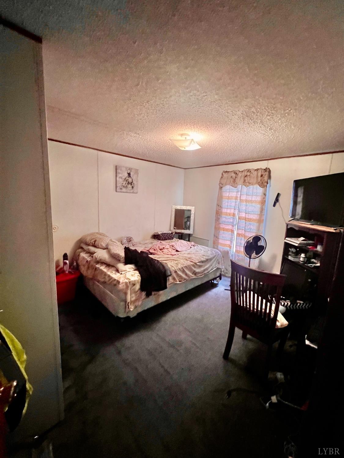 5507 Wards Road Evington, VA 24550 - Photo 8 of 15 a bedroom with furniture and a window