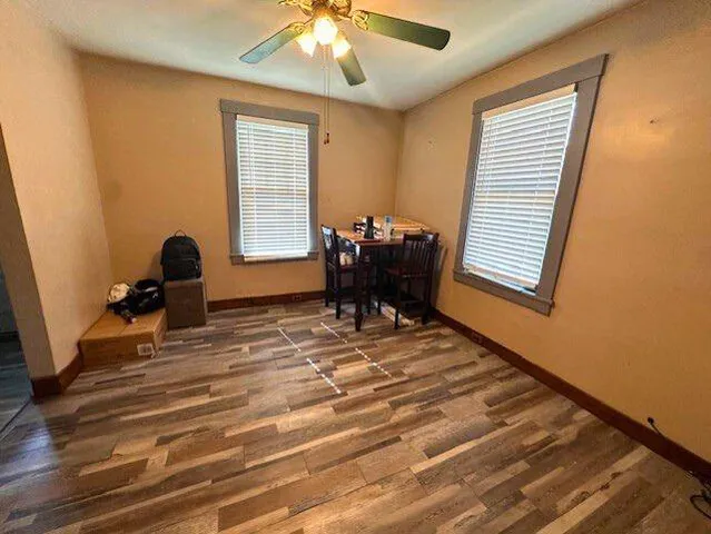 a room with wooden floor and windows