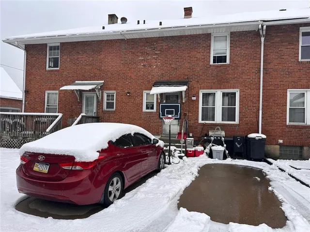 a front view of a house with parking space