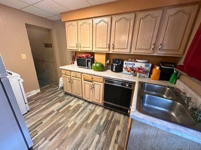 a kitchen with stainless steel appliances a stove a sink and a refrigerator