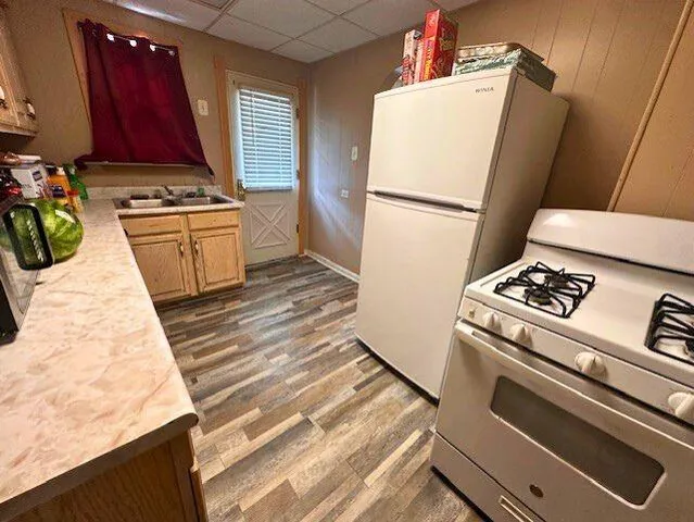 a kitchen with a stove top oven and a refrigerator
