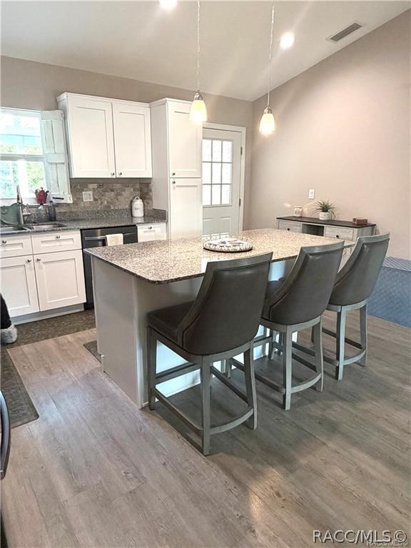 13591 Southwest 112th Street Dunnellon, FL 34432 - Photo 2 of 24 a kitchen with a table chairs a sink dishwasher window and cabinets