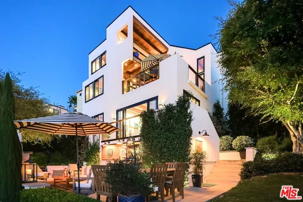 a front view of a house with a garden