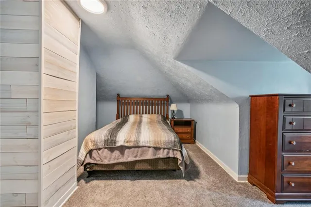 a bedroom with a bed and dresser