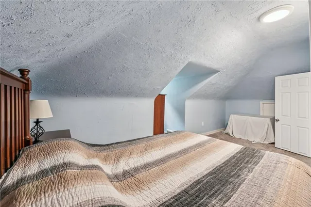 a bedroom with a bed and a lamp