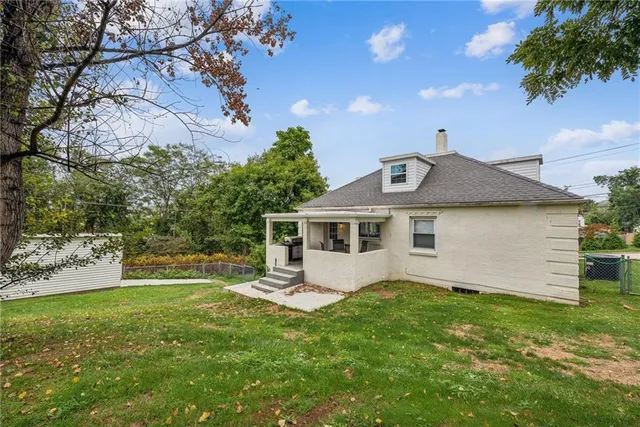 a front view of house with yard and green space