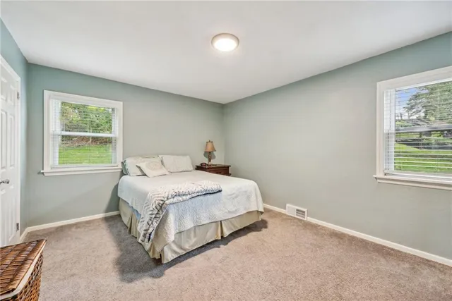 a spacious bedroom with a bed and a window